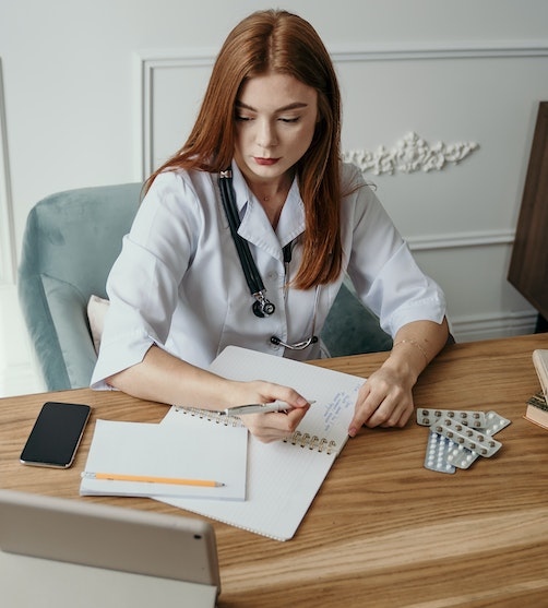 A doctor writing on a paper