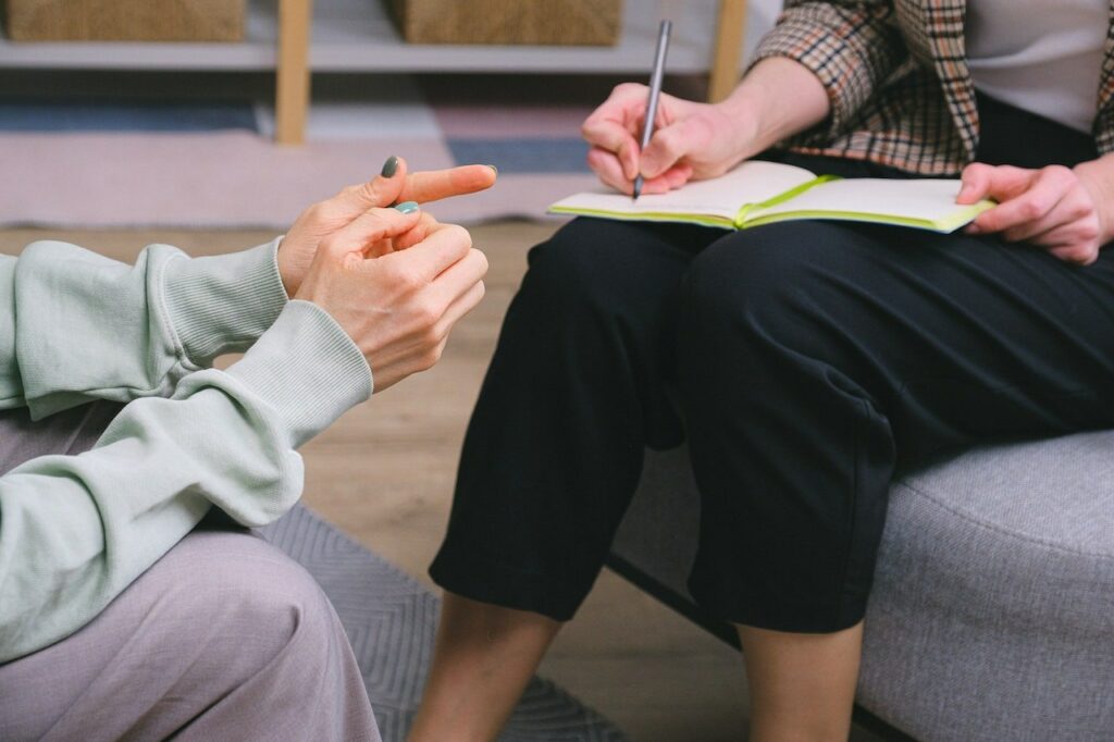 Cropped woman writing on a notebook